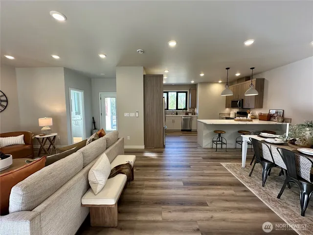 a living room with furniture and a wooden floor