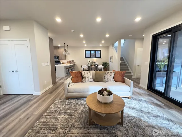 a living room with furniture and a wooden floor