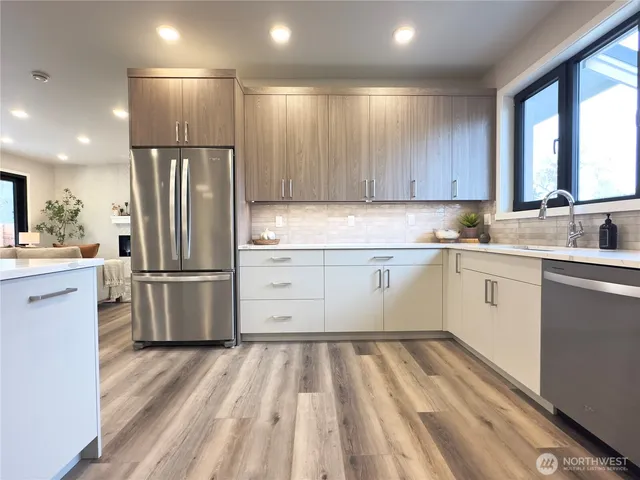 a kitchen with a refrigerator sink and cabinets
