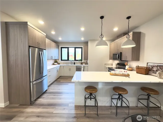 a large kitchen with a table and chairs