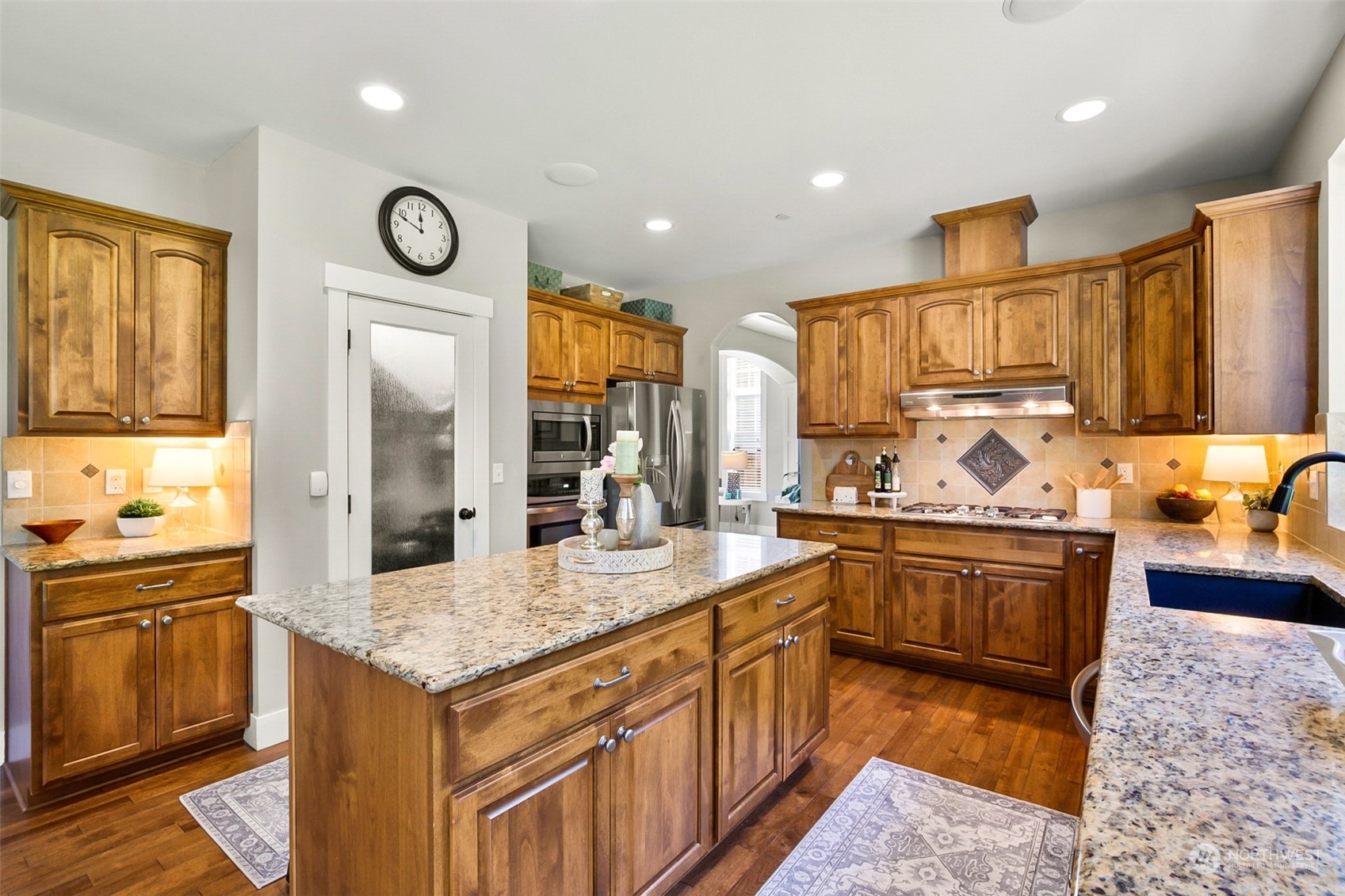 21808 31st Drive Southeast Bothell, WA 98021 - Photo 13 of 39 a kitchen with stainless steel appliances granite countertop a sink and stove top oven