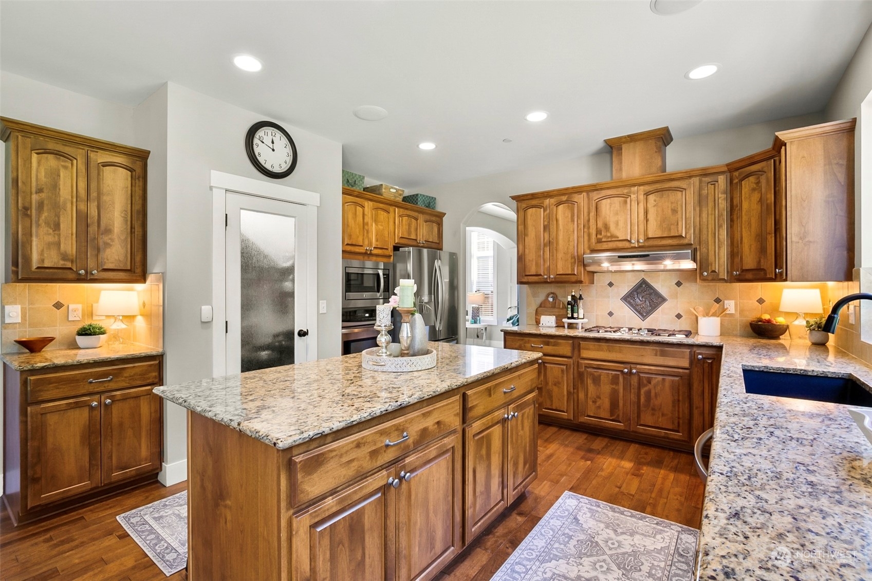 21808 31st Drive Southeast Bothell, WA 98021 - Photo 16 of 39 a kitchen with stainless steel appliances granite countertop a sink and stove top oven