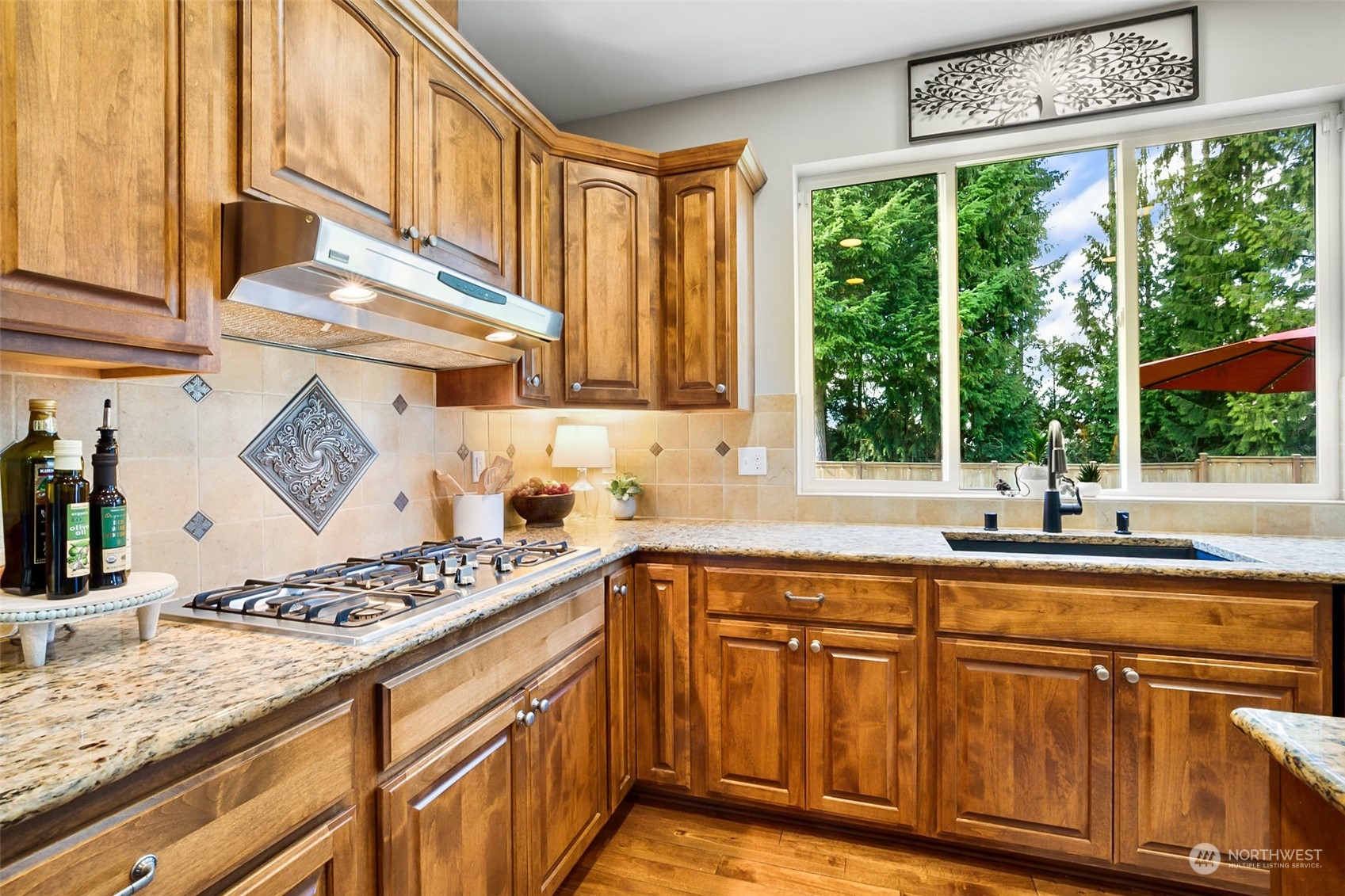 21808 31st Drive Southeast Bothell, WA 98021 - Photo 17 of 39 a kitchen with stainless steel appliances granite countertop a stove a sink and a microwave