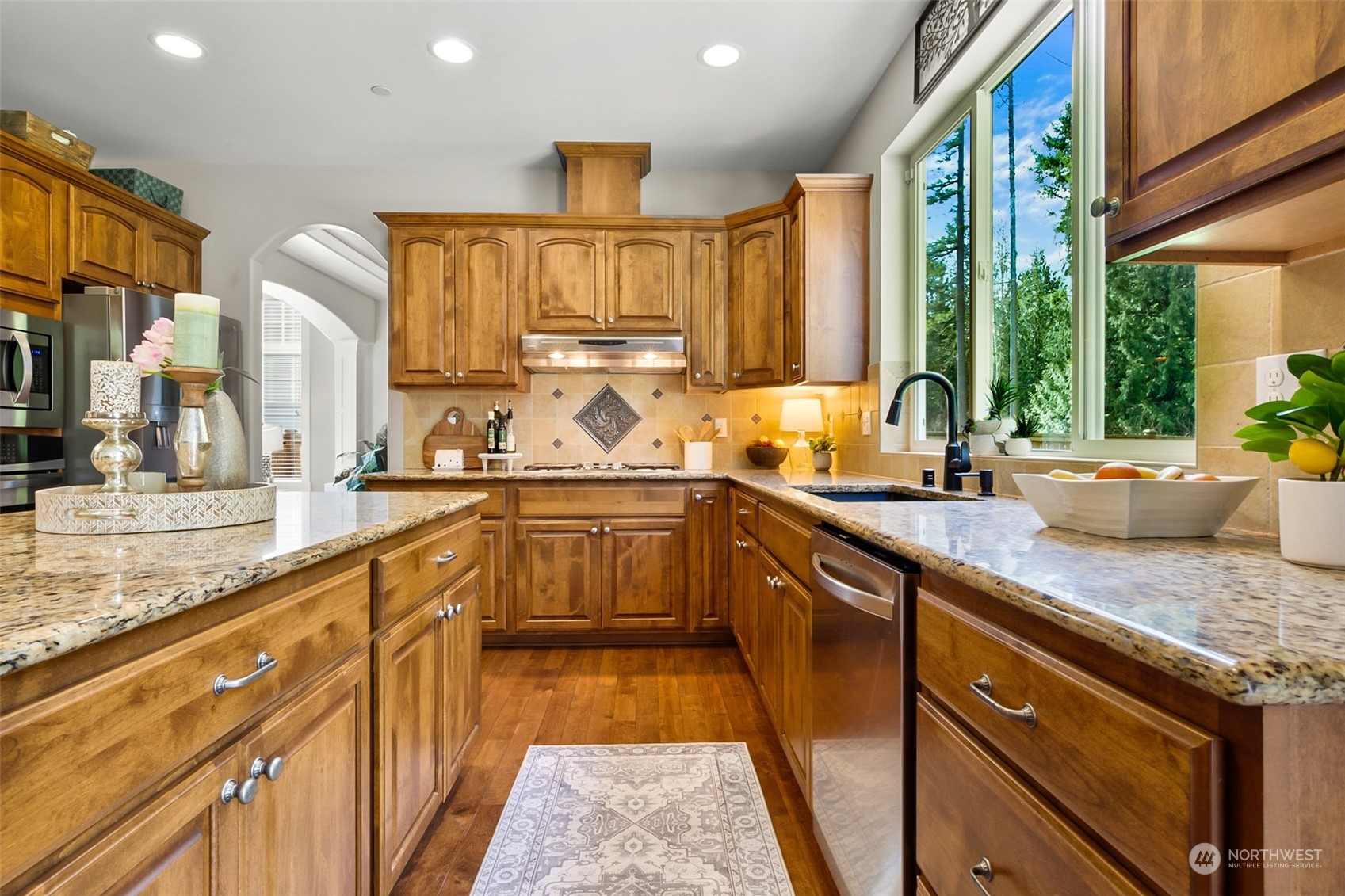 21808 31st Drive Southeast Bothell, WA 98021 - Photo 18 of 39 a kitchen with stainless steel appliances granite countertop sink stove and cabinets