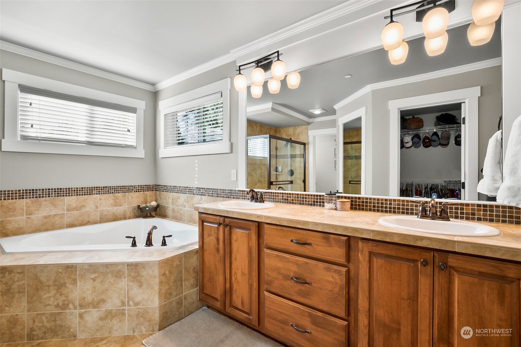 21808 31st Drive Southeast Bothell, WA 98021 - Photo 27 of 39 a bathroom with a bathtub a double vanity sink and a large mirror