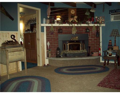 3317 North Hermitage Road Transfer, PA 16154 - Photo 4 of 18 Living Room. Attractive wood burning fireplace with insert sits in the coner of the large living room. Doorway leads to the computer room or can be used as a third bedroom.