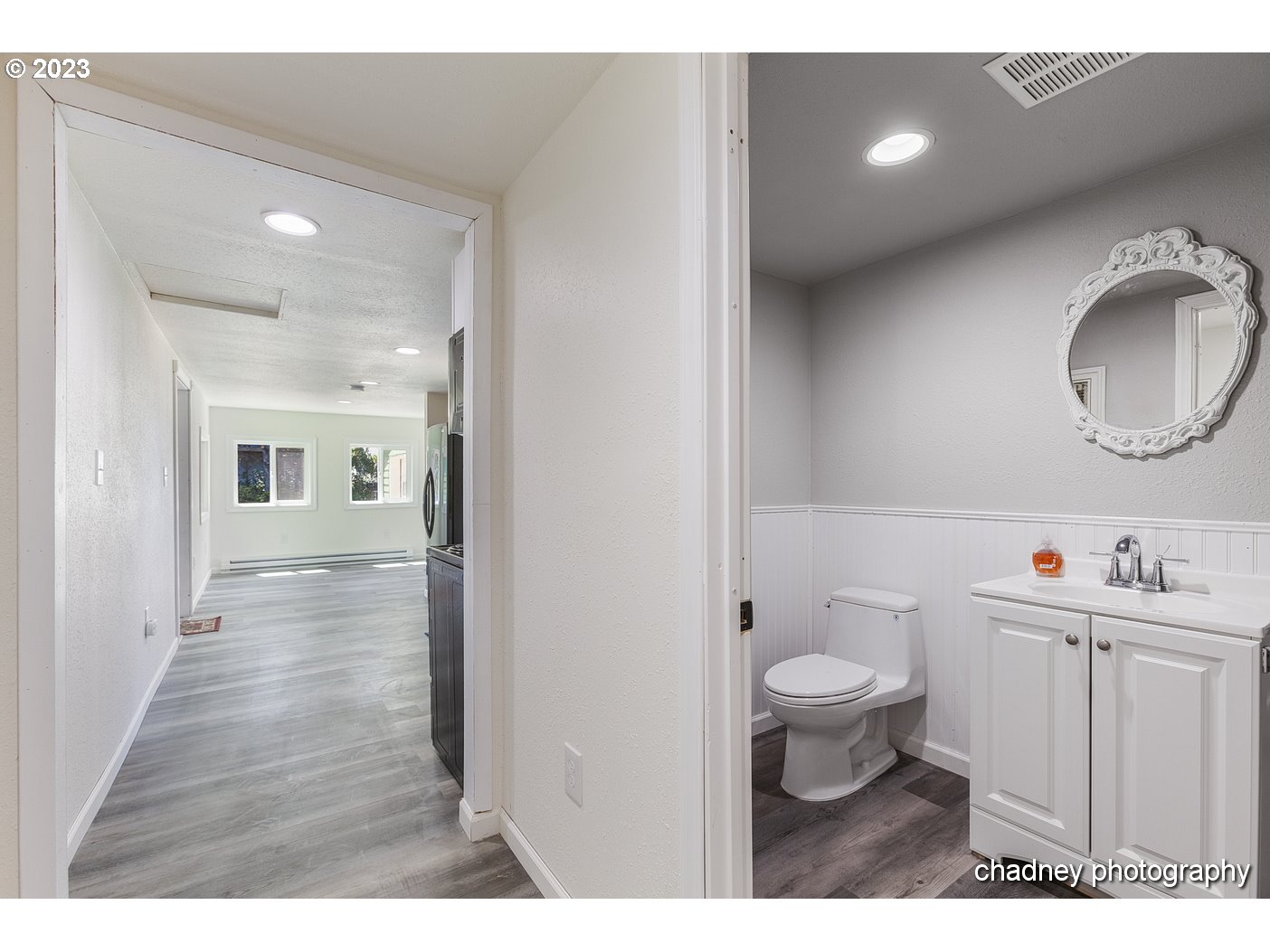 5707 Northwest Rhododendron Street Newport, OR 97365 - Photo 13 of 20 a bathroom with a toilet sink a mirror and vanity