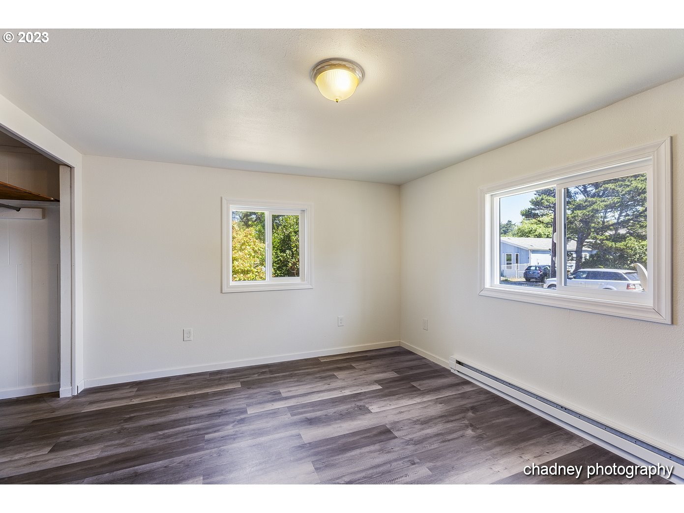 5707 Northwest Rhododendron Street Newport, OR 97365 - Photo 14 of 20 a view of an empty room with wooden floor and a window