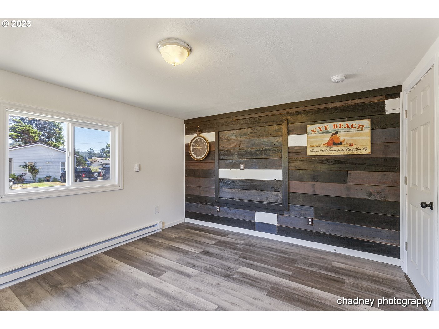 5707 Northwest Rhododendron Street Newport, OR 97365 - Photo 15 of 20 a view of empty room with wooden floor