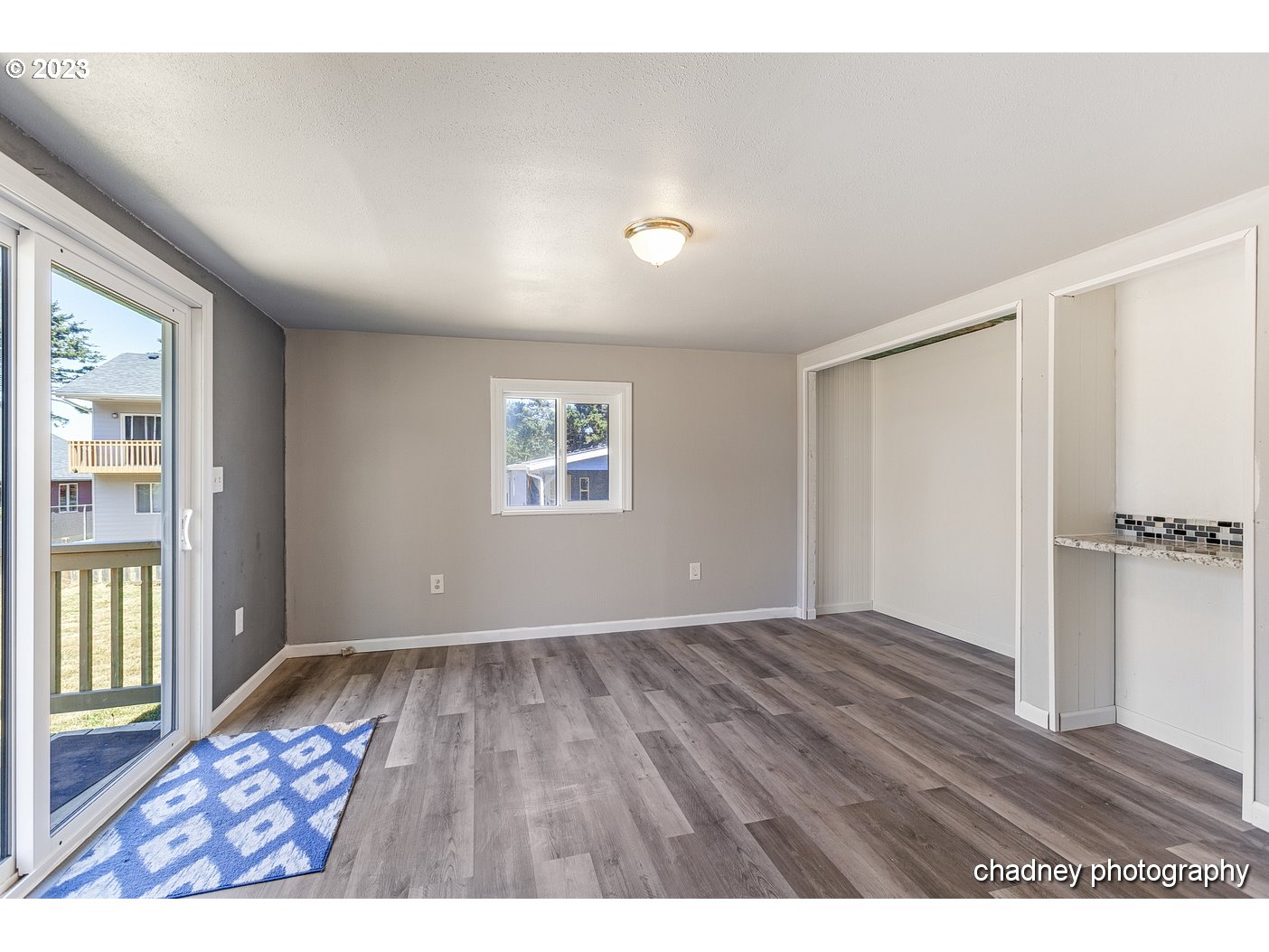 5707 Northwest Rhododendron Street Newport, OR 97365 - Photo 16 of 20 a view of an empty room with wooden floor and a window