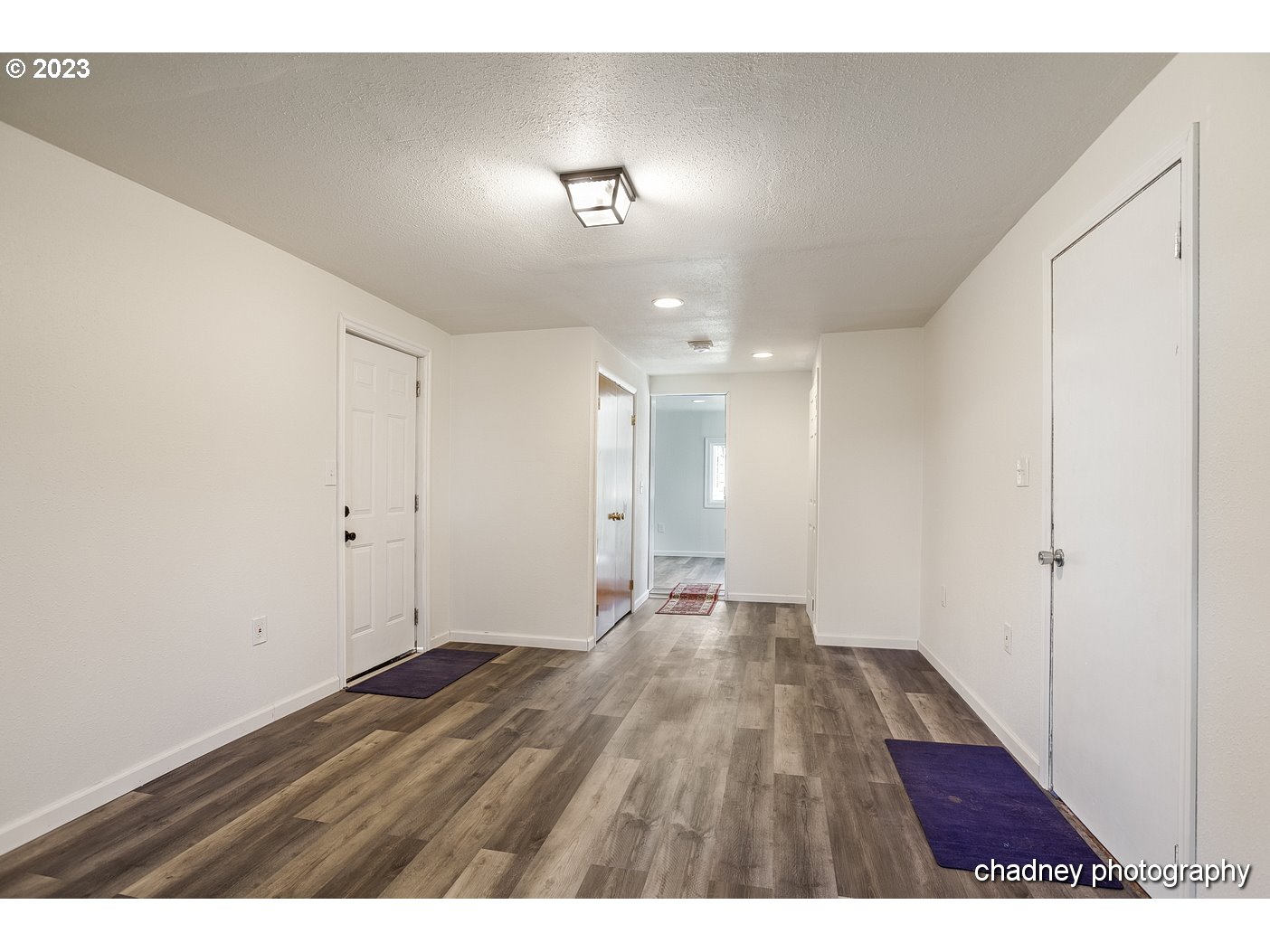 5707 Northwest Rhododendron Street Newport, OR 97365 - Photo 18 of 20 a view of an empty room with wooden floor