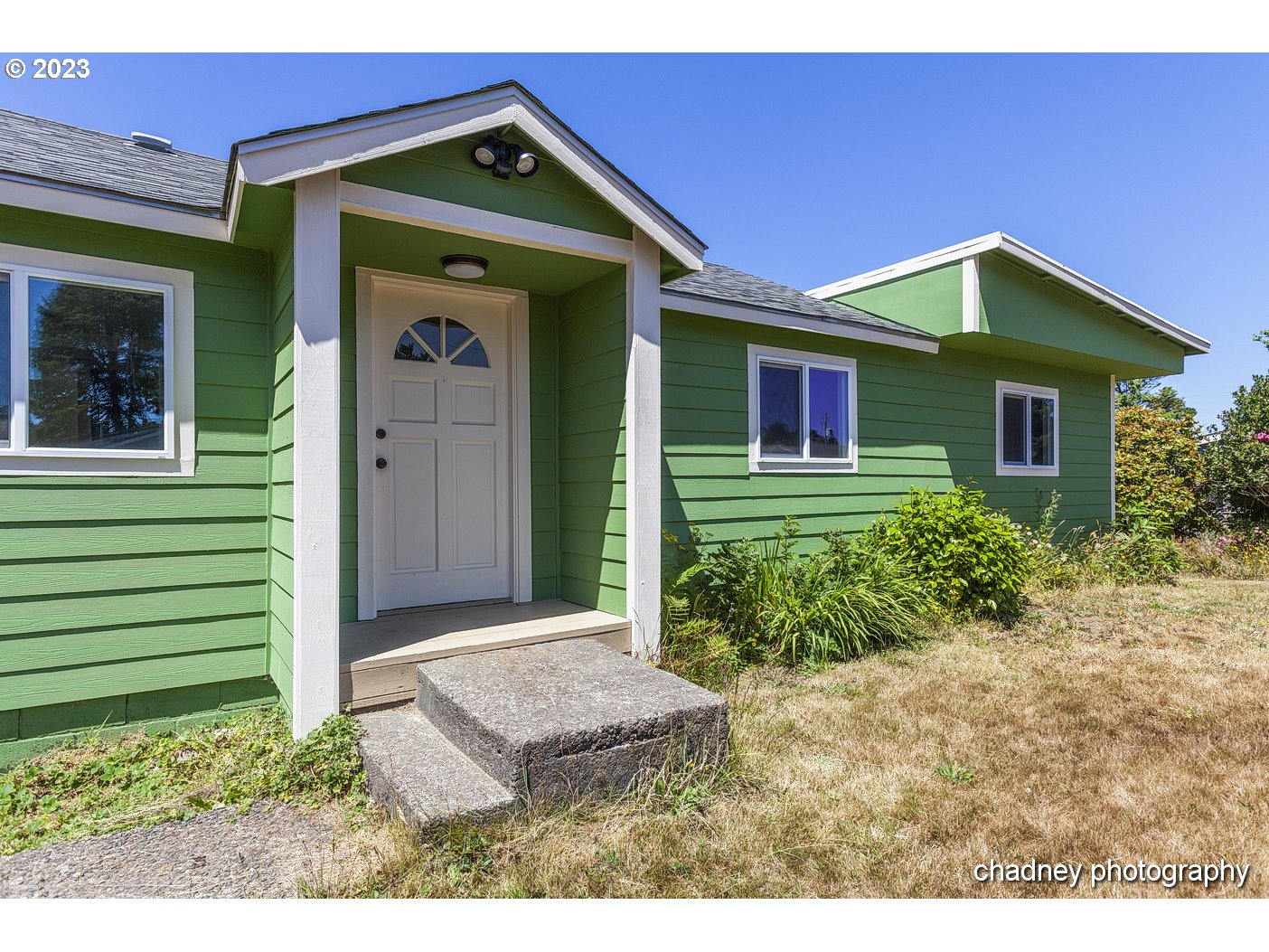 5707 Northwest Rhododendron Street Newport, OR 97365 - Photo 2 of 20 a front view of a house with garden