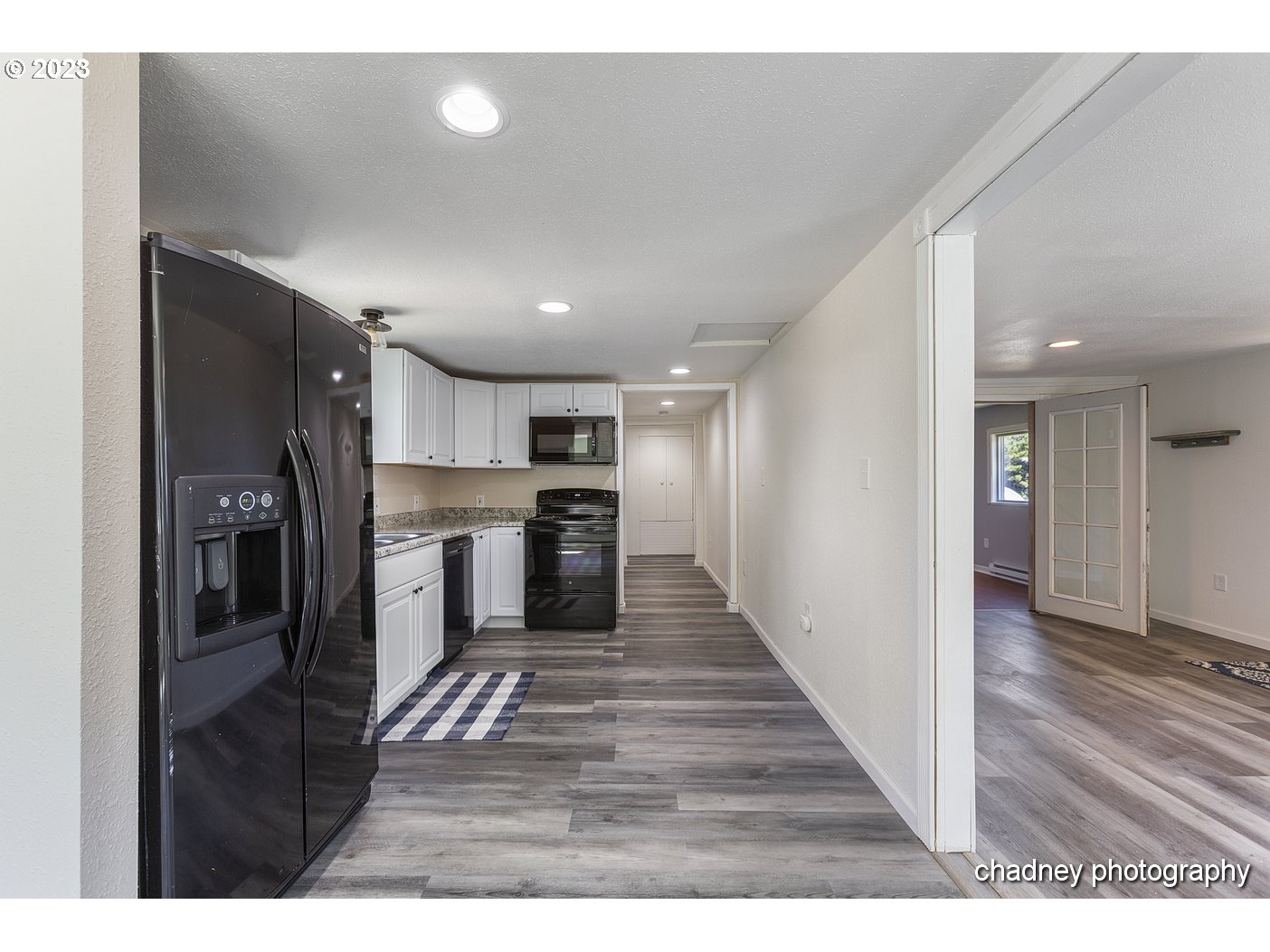 5707 Northwest Rhododendron Street Newport, OR 97365 - Photo 3 of 20 a open kitchen with refrigerator and a stove