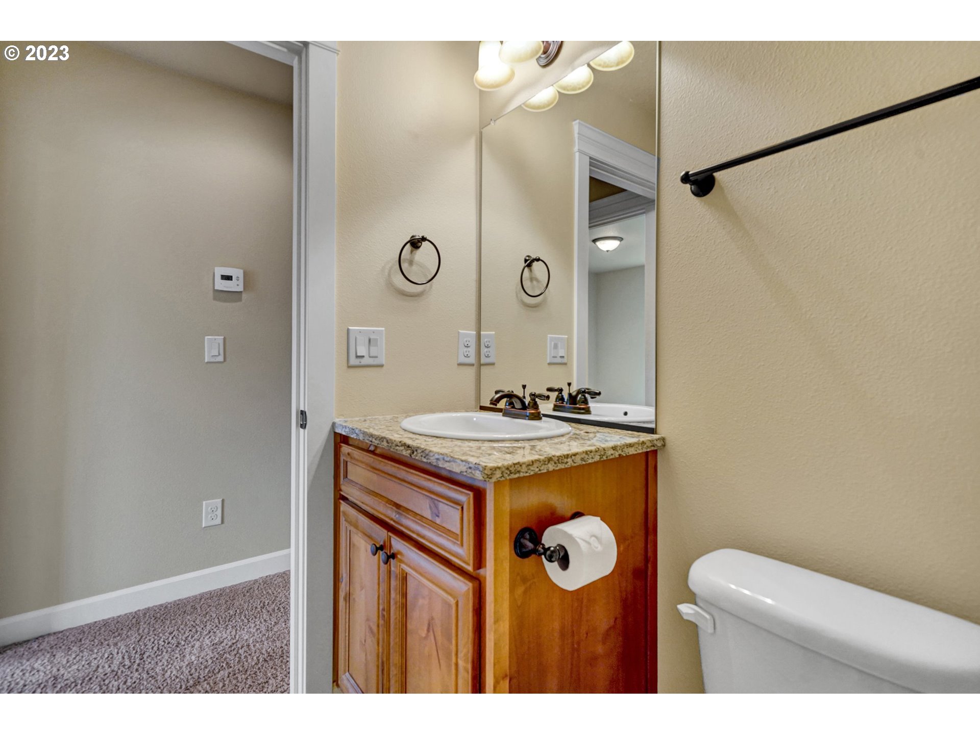 235 North 33rd Court Ridgefield, WA 98642 - Photo 25 of 30 a bathroom with a sink mirror vanity and toilet