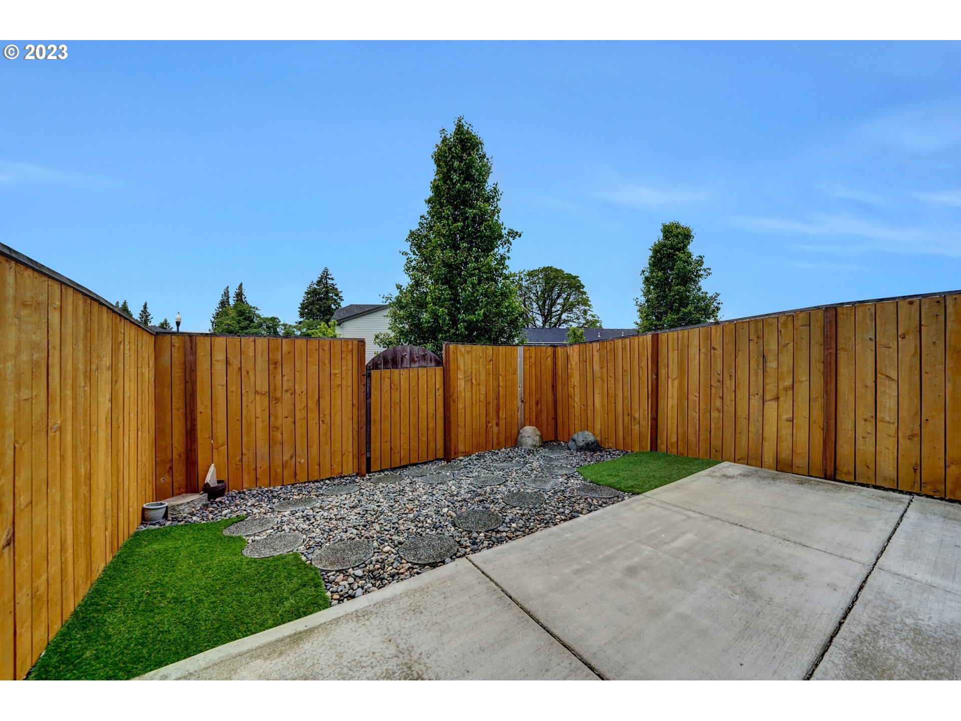 235 North 33rd Court Ridgefield, WA 98642 - Photo 28 of 30 a view of backyard with potted plants and wooden fence