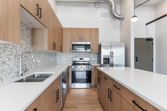 a kitchen with a sink stove and refrigerator
