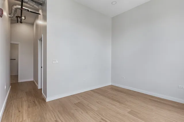 a view of a room with wooden floor