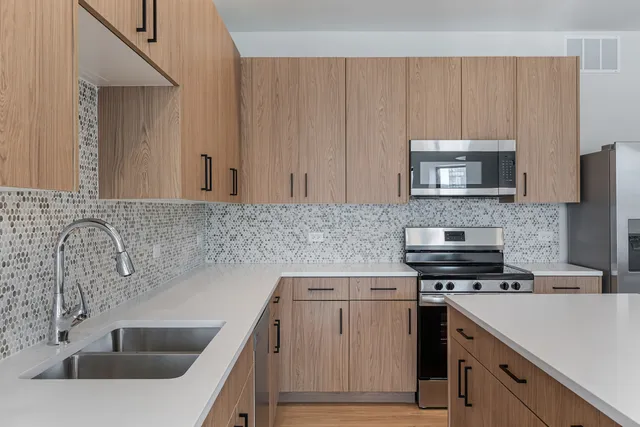 a kitchen with a sink stove and microwave