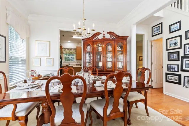 a view of a a dining room with furniture window and wooden floor