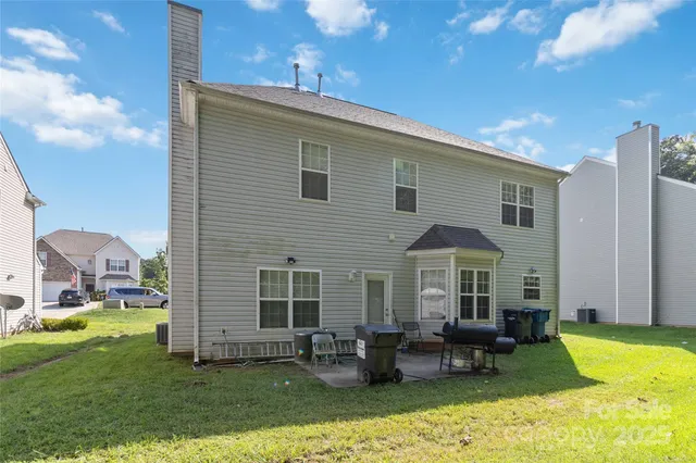 a front view of a house with swimming pool having outdoor seating