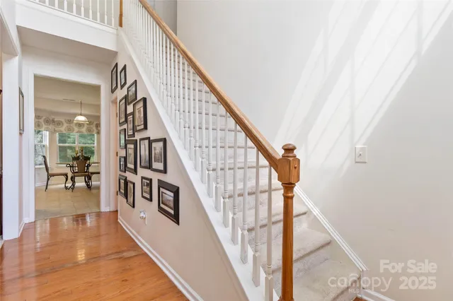 a view of entryway and hall with wooden floor