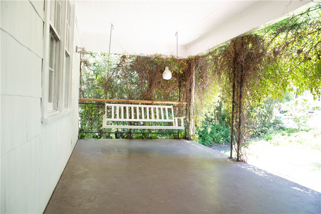 Oversized front porch with a cozy swing to relax o