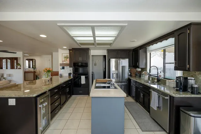 a large kitchen with kitchen island granite countertop lots of counter top space