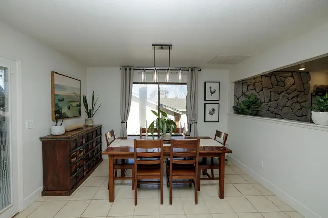 a dining room with furniture and window