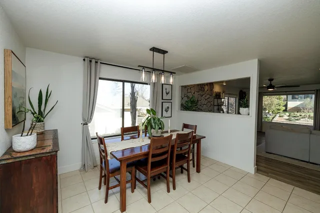 a dining room with furniture window and wooden floor