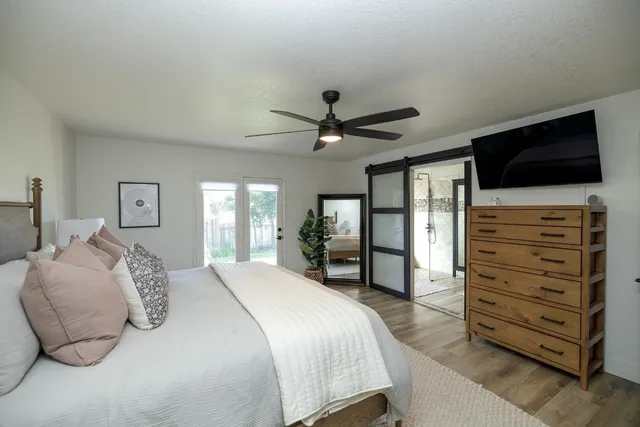a bedroom with a bed and a flat screen tv
