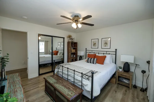 a bedroom with a bed and a chandelier