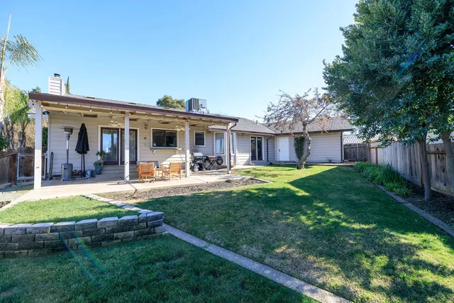 a view of a house with a yard patio and swimming pool