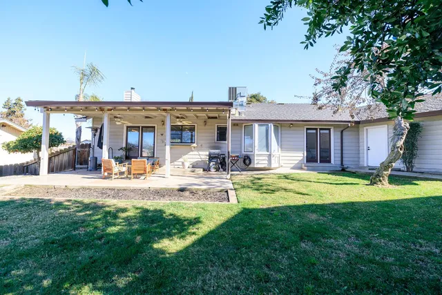 a view of a house with a yard patio and swimming pool