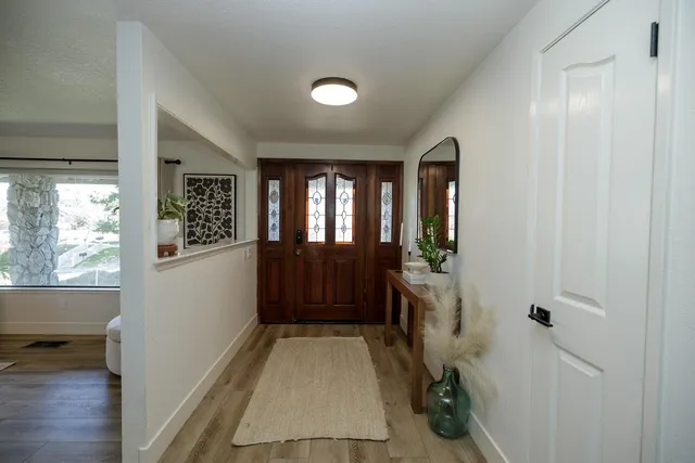a view of entryway with window and wooden floor