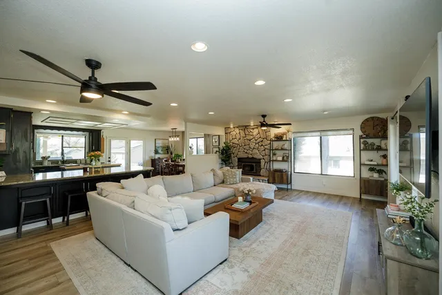 a living room with fireplace furniture and a large window