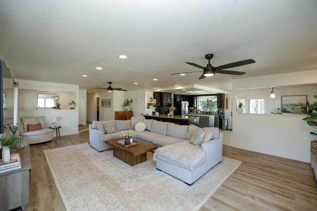 a living room with furniture and a ceiling fan