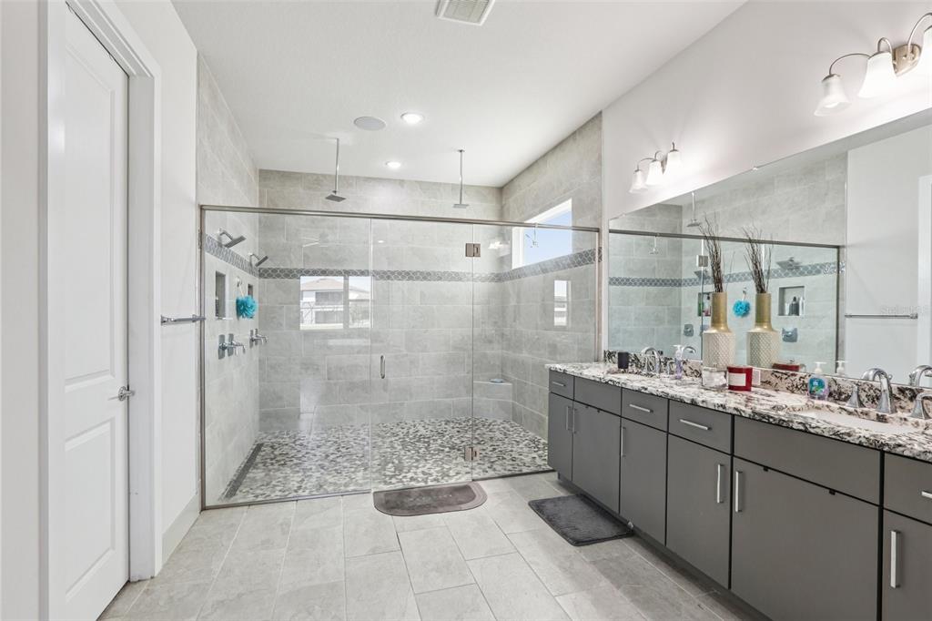 8743 Sanders Tree Loop Wesley Chapel, FL 33545 - Photo 16 of 41 a bathroom with a double vanity sink mirror and shower