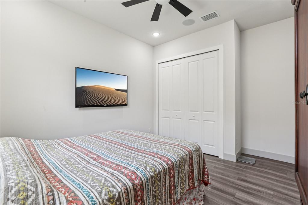 8743 Sanders Tree Loop Wesley Chapel, FL 33545 - Photo 22 of 41 a bedroom with a bed and a flat screen tv