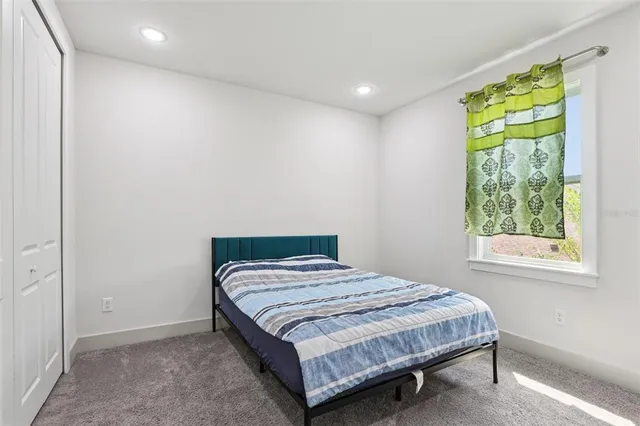 a bedroom with a bed and a window