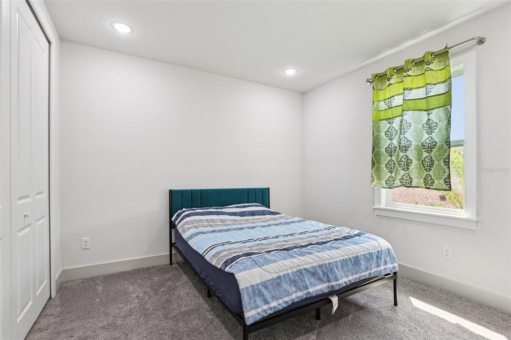 8743 Sanders Tree Loop Wesley Chapel, FL 33545 - Photo 32 of 41 a bedroom with a bed and a window