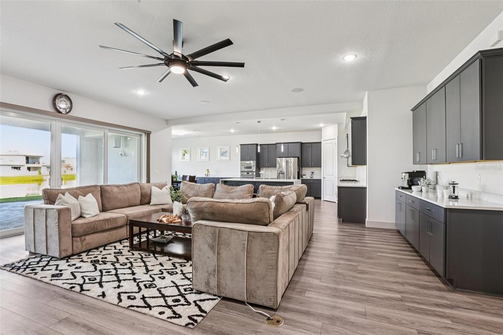 8743 Sanders Tree Loop Wesley Chapel, FL 33545 - Photo 5 of 41 a living room with furniture and a wooden floor