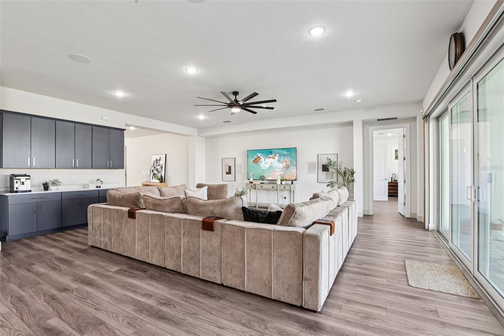 8743 Sanders Tree Loop Wesley Chapel, FL 33545 - Photo 6 of 41 a living room with furniture and a wooden floor