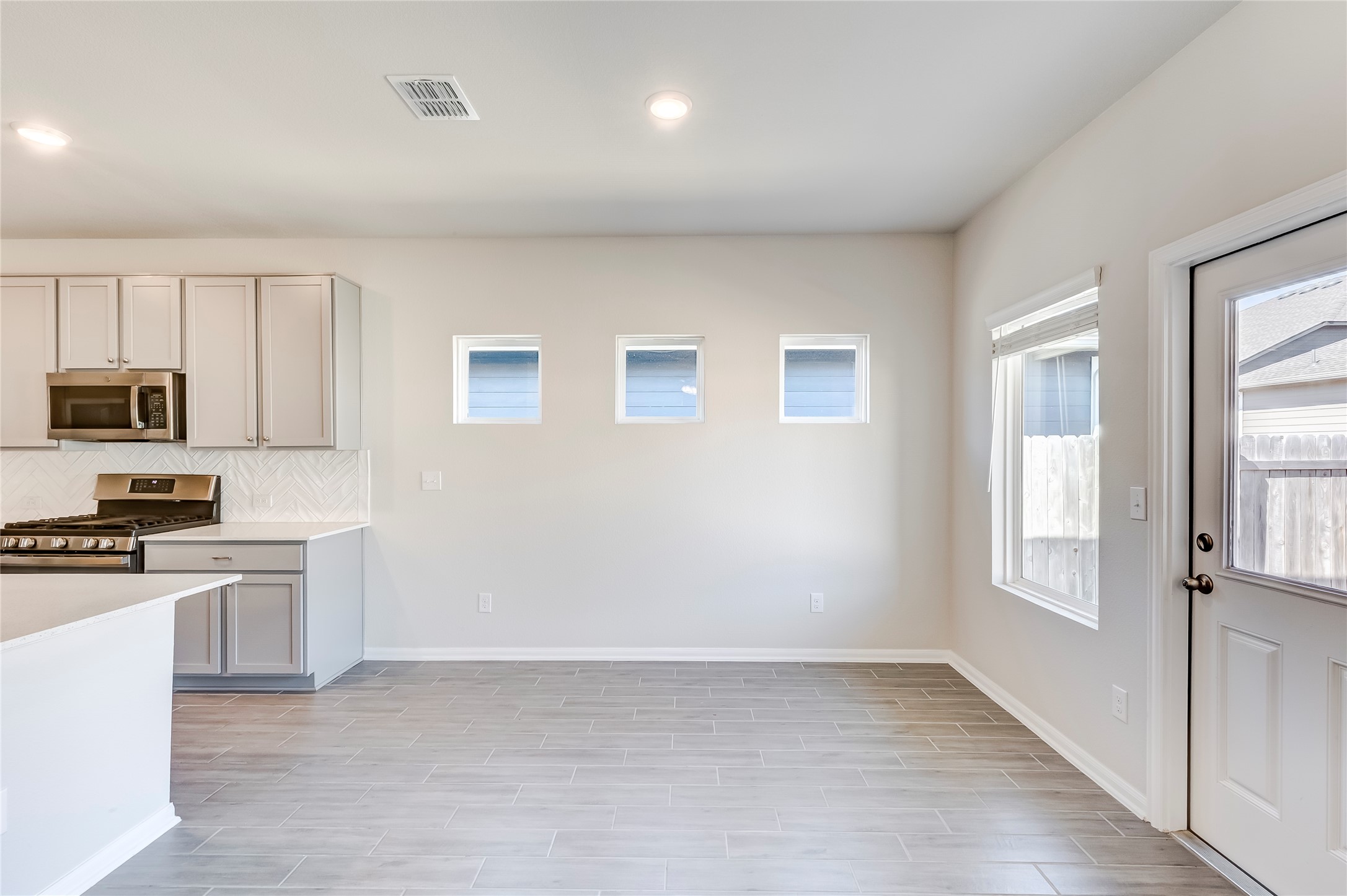 141 Yellowstone Drive Kyle, TX 78640 - Photo 13 of 33 a view of a kitchen with microwave and stove top oven