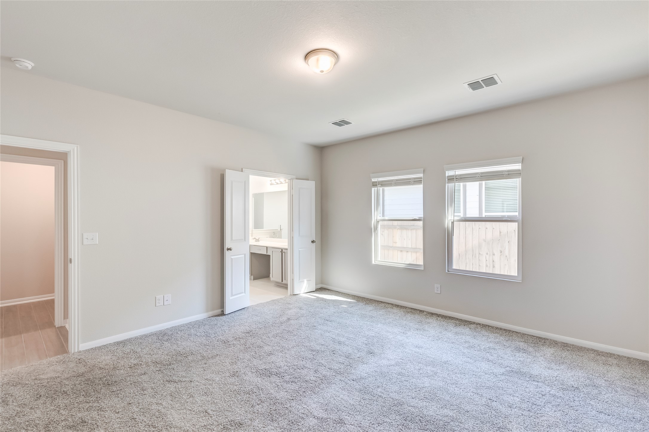 141 Yellowstone Drive Kyle, TX 78640 - Photo 16 of 33 a view of an empty room with a window and wooden floor
