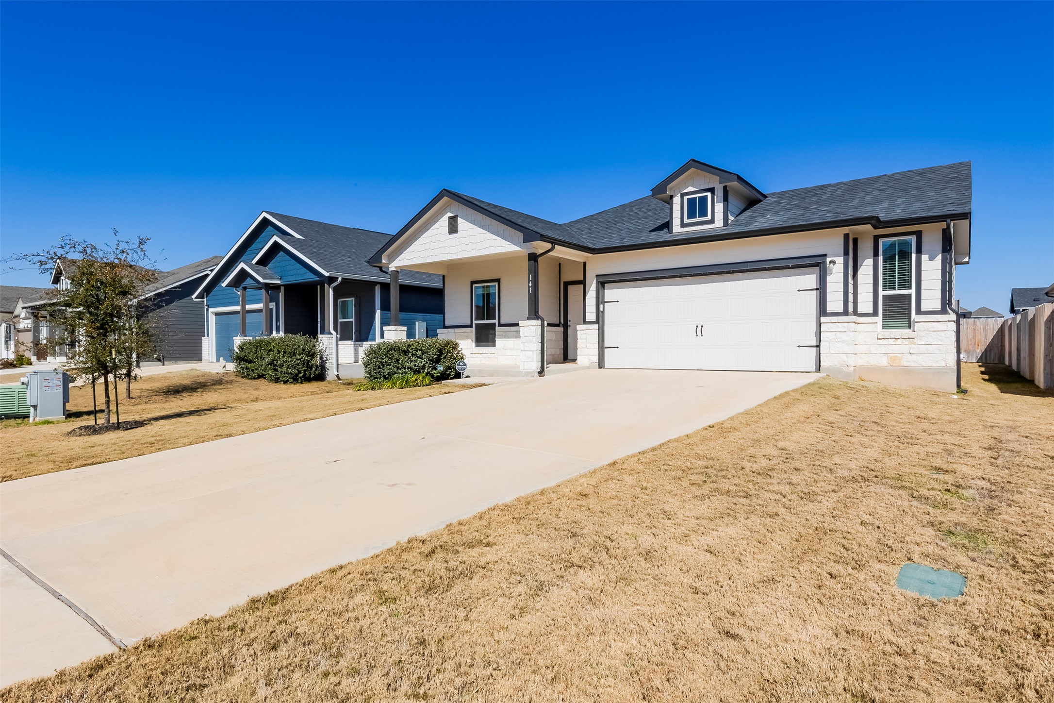 141 Yellowstone Drive Kyle, TX 78640 - Photo 2 of 33 a front view of a house with a yard