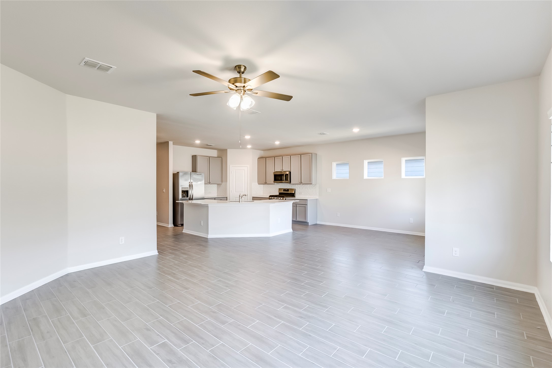 141 Yellowstone Drive Kyle, TX 78640 - Photo 8 of 33 a view of an empty room with kitchen and window