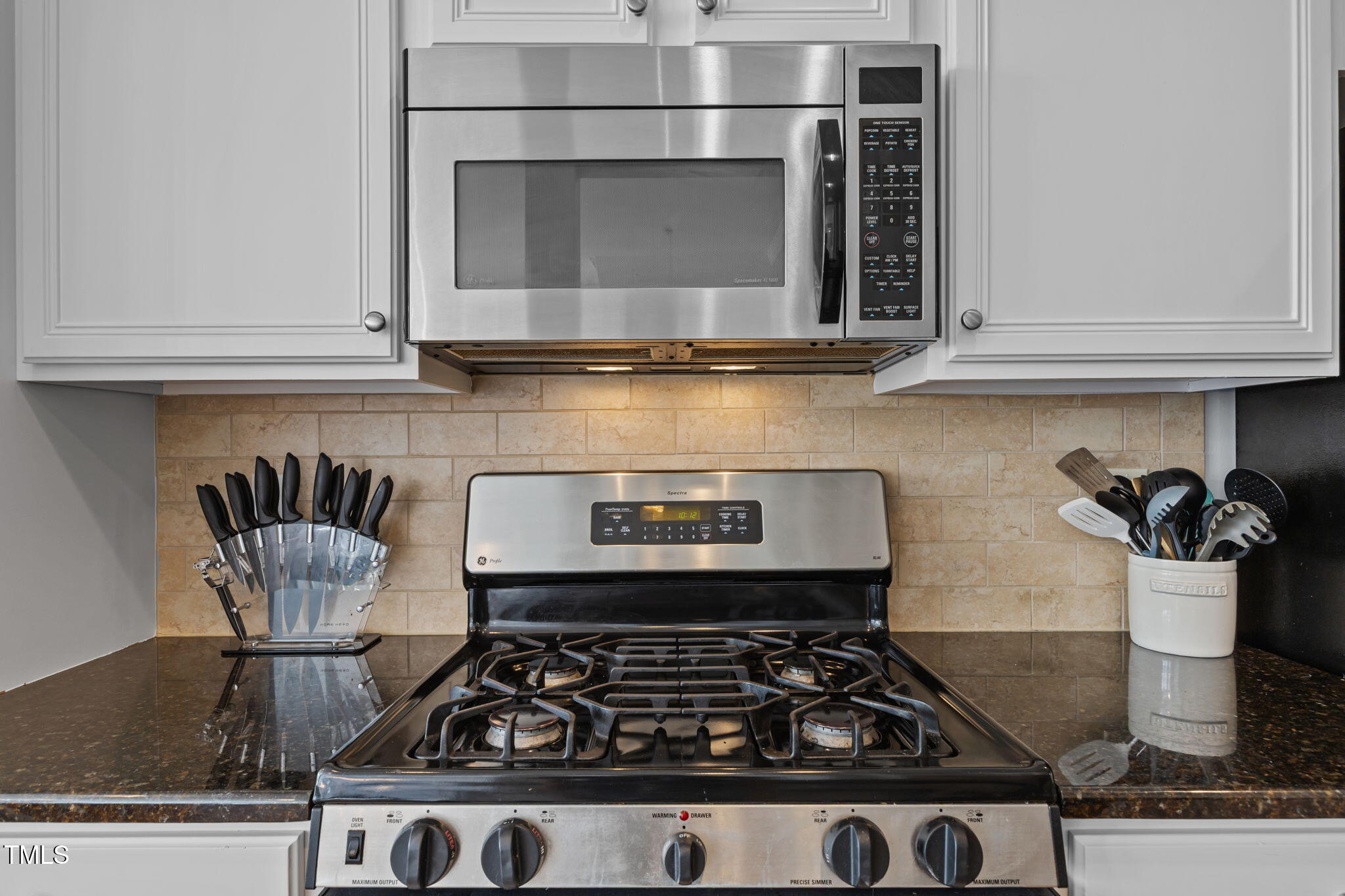 6825 Middleboro Drive Raleigh, NC 27612 - Photo 11 of 38 a kitchen with a stove and a microwave