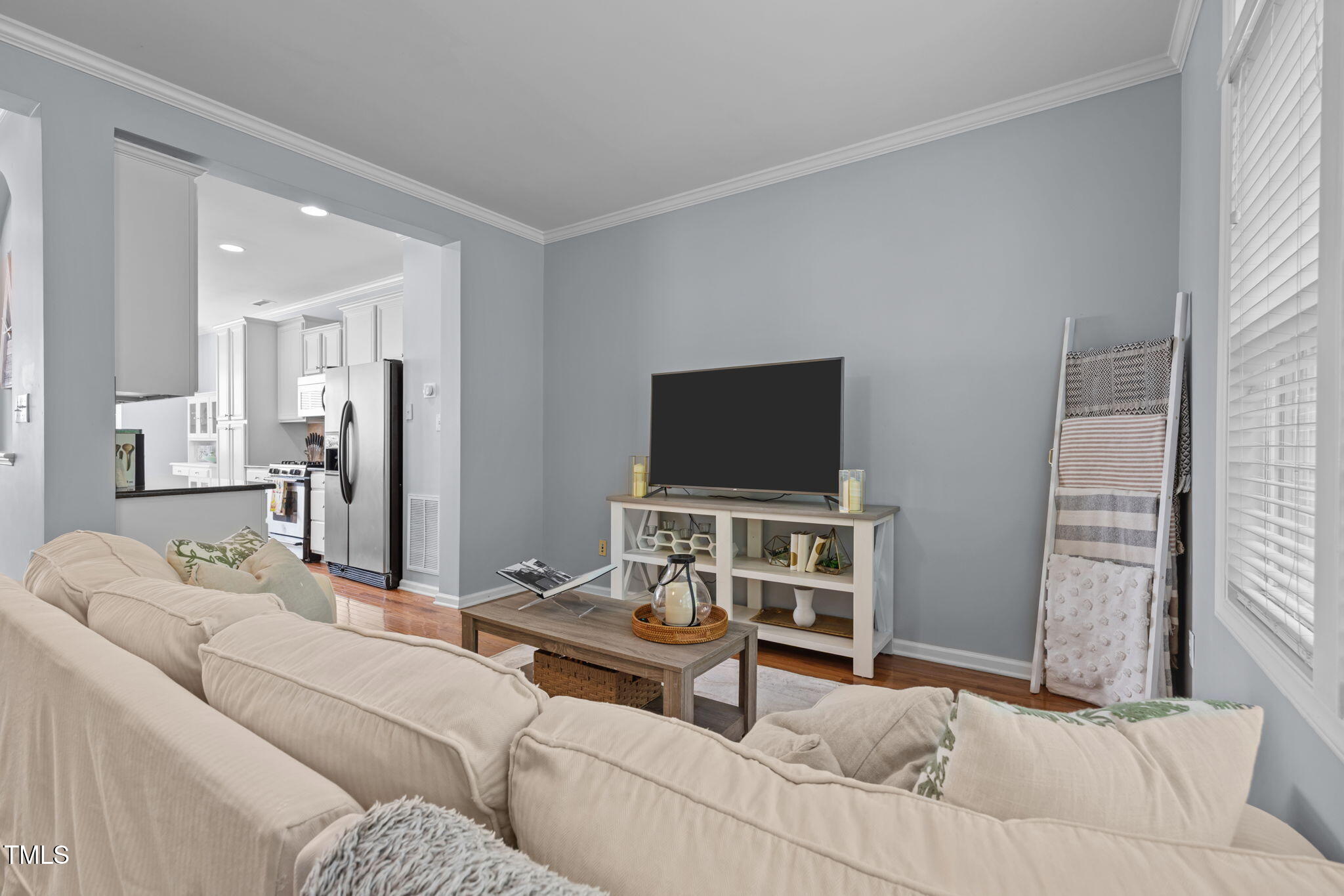 6825 Middleboro Drive Raleigh, NC 27612 - Photo 16 of 38 a living room with furniture and a flat screen tv