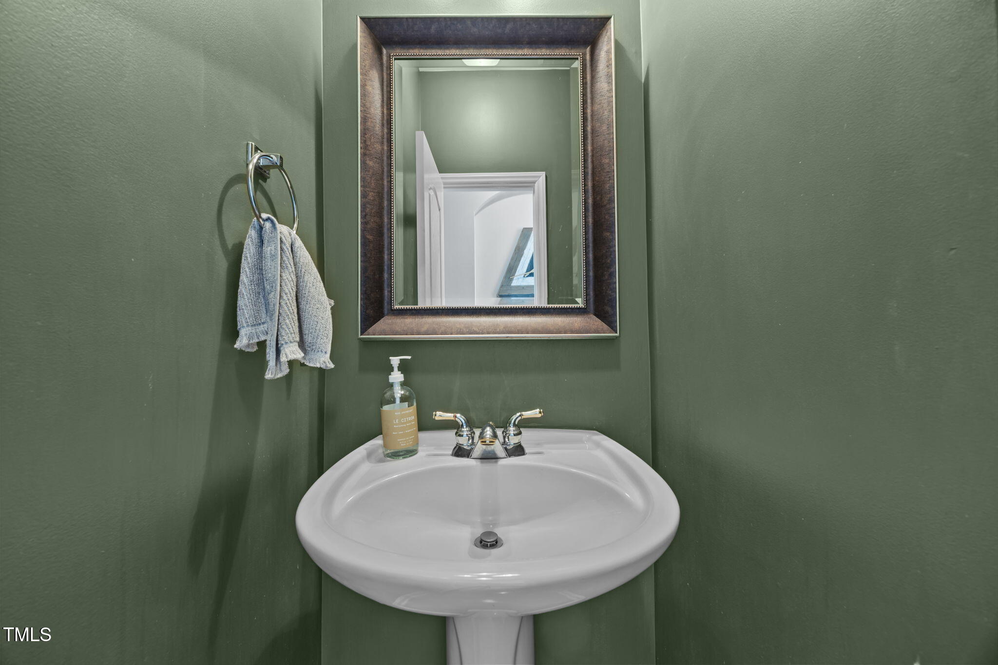 6825 Middleboro Drive Raleigh, NC 27612 - Photo 20 of 38 a bathroom with a sink and a mirror