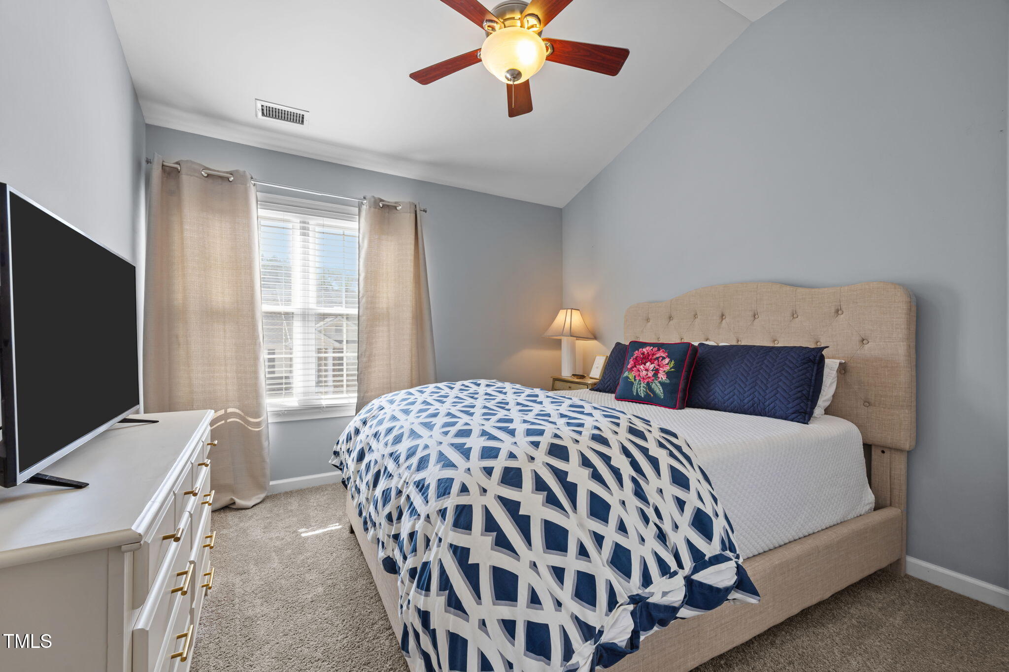 6825 Middleboro Drive Raleigh, NC 27612 - Photo 22 of 38 a bedroom with a bed and a flat screen tv